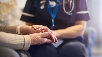 Nurse comforting patient at patient's home