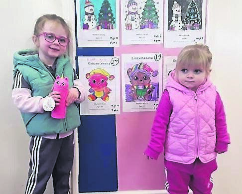 Eibhlís Yelverton, who came second in the Age 3-5 category in Mayfield Library’s Christmas colouring competition, with her little sister Orlagh.