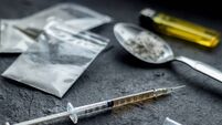 drug syringe and cooked heroin on spoon. drug addict problem and therapy concept