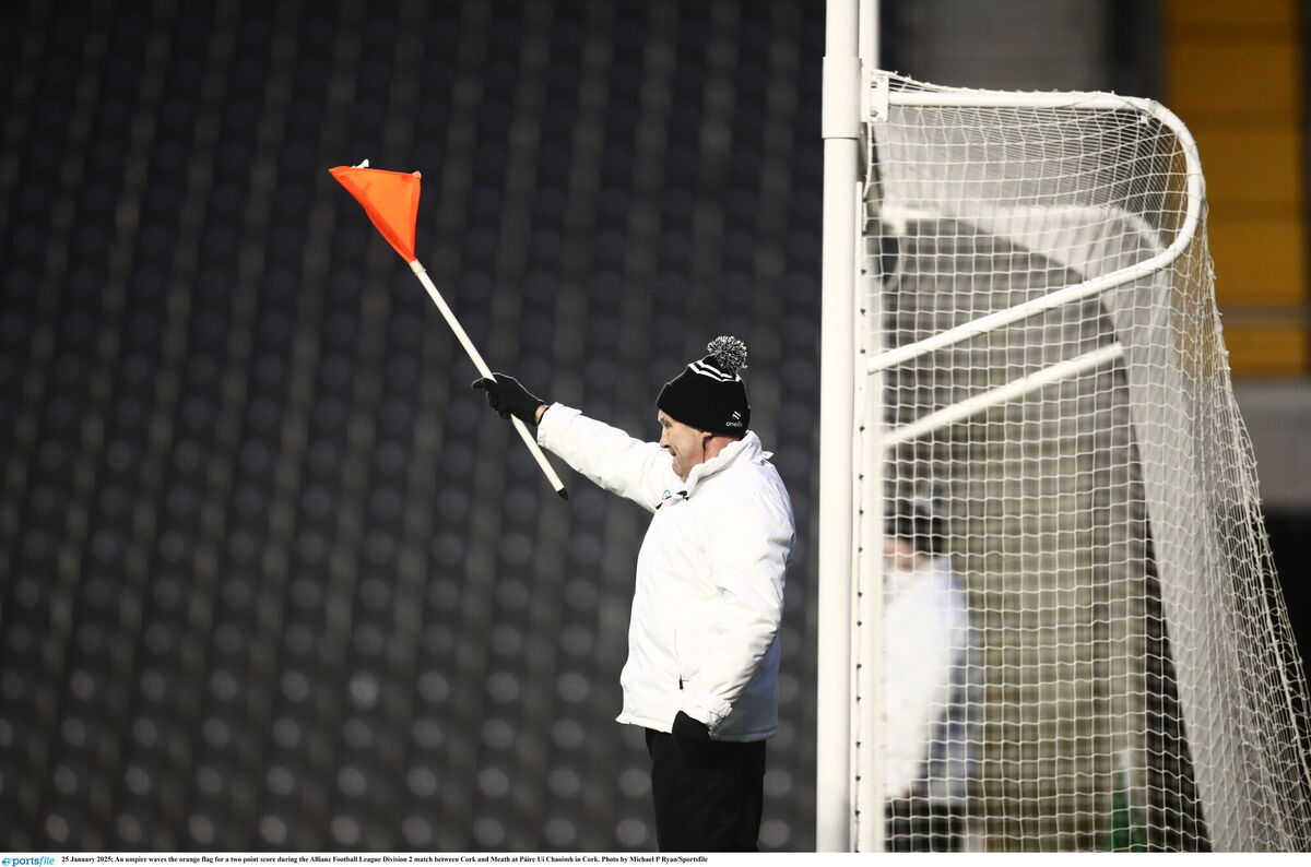 An umpire waves the orange flag for a two-point score during the Cork v Meath game. Picture: Michael P Ryan/Sportsfile