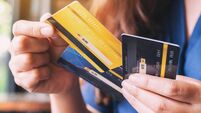 a woman holding and choosing credit card to use