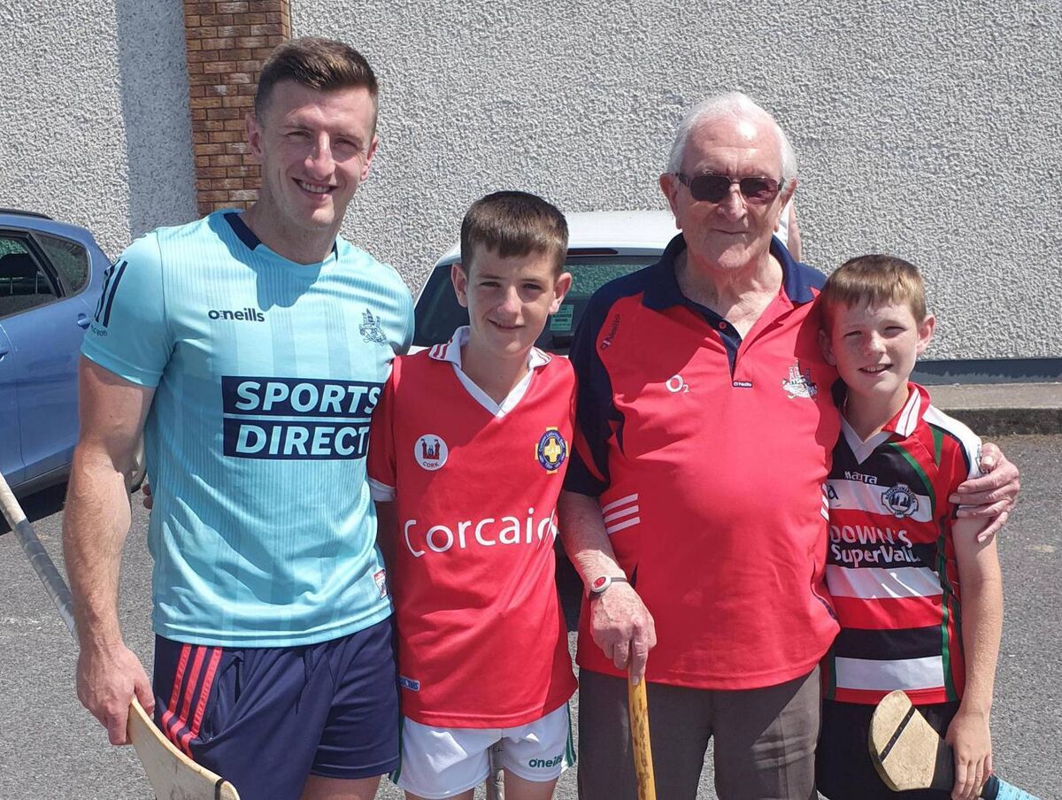 Eddie Hogan and his great-grandsons Tadhg Murphy and Daithí Murphy in Glen Rovers with Patrick Horgan after a hurling camp. 