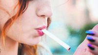 Close-Up Of Woman Burning Cigarette