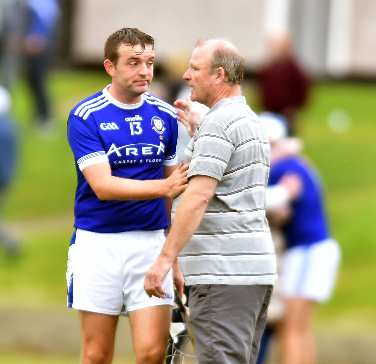 Brian Dillons John Horgan is congratulated by Teddy McCarthy after defeating Passage in the Sports Turf Solutions City Division JAHC final at Ballinlough