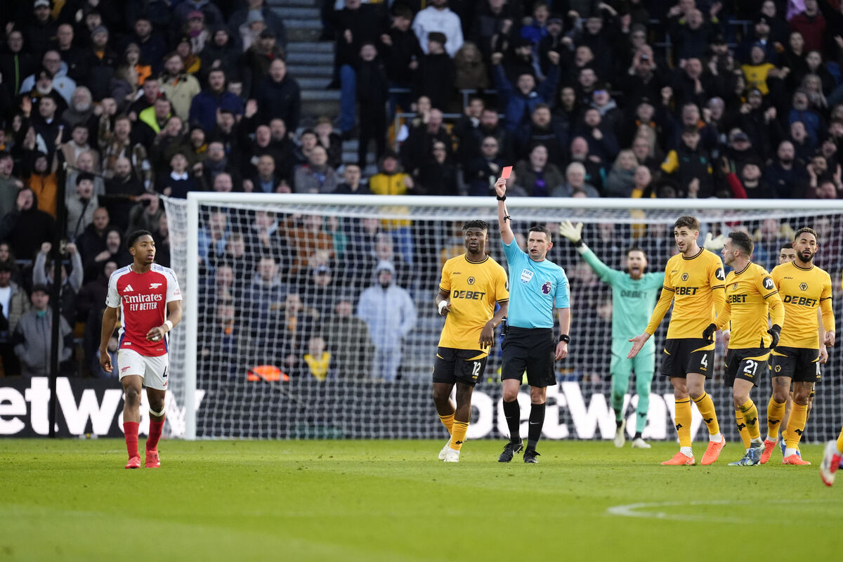 Arsenal's Myles Lewis-Skelly is shown a red card by referee Michael Oliver during the Premier League match at Molineux Stadium, Wolverhampton. 