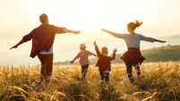 Happy family: mother, father, children son and daughter on sunset