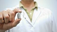 Doctor showing hearing aid
