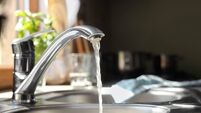 Water running from tap into kitchen sink