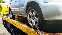 Car being attached to tow truck
