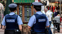The Garda (Police) often patrol in pairs on busy Grafton Street, popular with visitors and tourists in Dublin, Southern Ireland.
