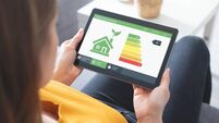 Energy efficiency mobile app on screen, eco house