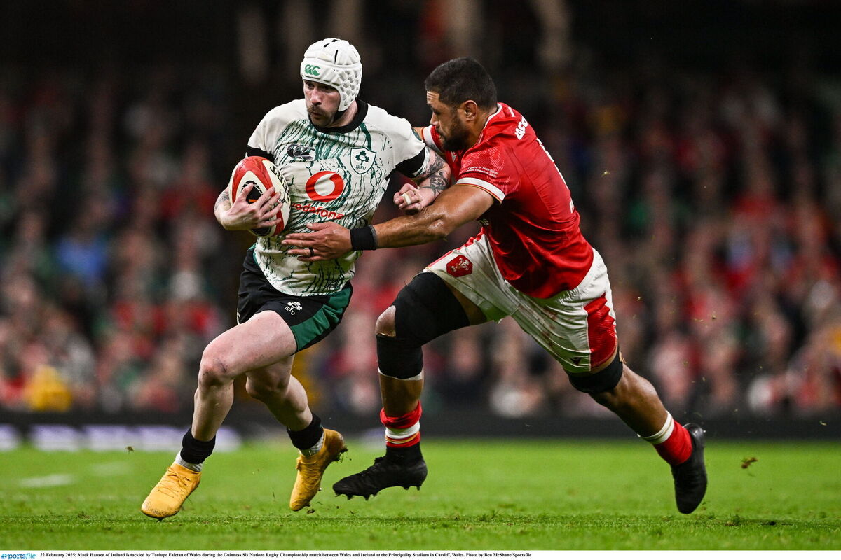 Mack Hansen of Ireland is tackled by Taulupe Faletau of Wales. Picture: Ben McShane/Sportsfile