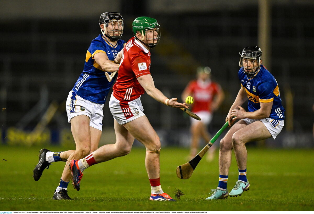 Cormac O'Brien of Cork handpasses under pressure from Gearoid O'Connor of Tipperary. Picture: Brendan Moran/Sportsfile Cormac O'Brien of Cork handpasses under pressure from Gearoid O'Connor of Tipperary. Picture: Brendan Moran/Sportsfile