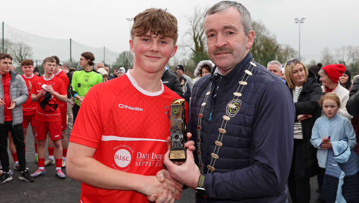  Ty Corcoran, Cork Youth League, receives the Player of the Match award from John Buckley, Chairperson Munster FA.
