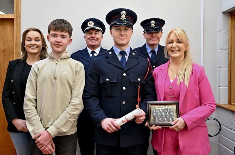 The O'Brien family are third generation firefighters, pictured attending the passing out off the newest family recruit, Colin are extended family members Fiona, Aidan, his father Robert, third officer, his Uncle Steven and his mother Linda who holds a photograph of his late grandfather Bob, now deceased, served in the fire brigade for 28 years. Picture Chani Anderson