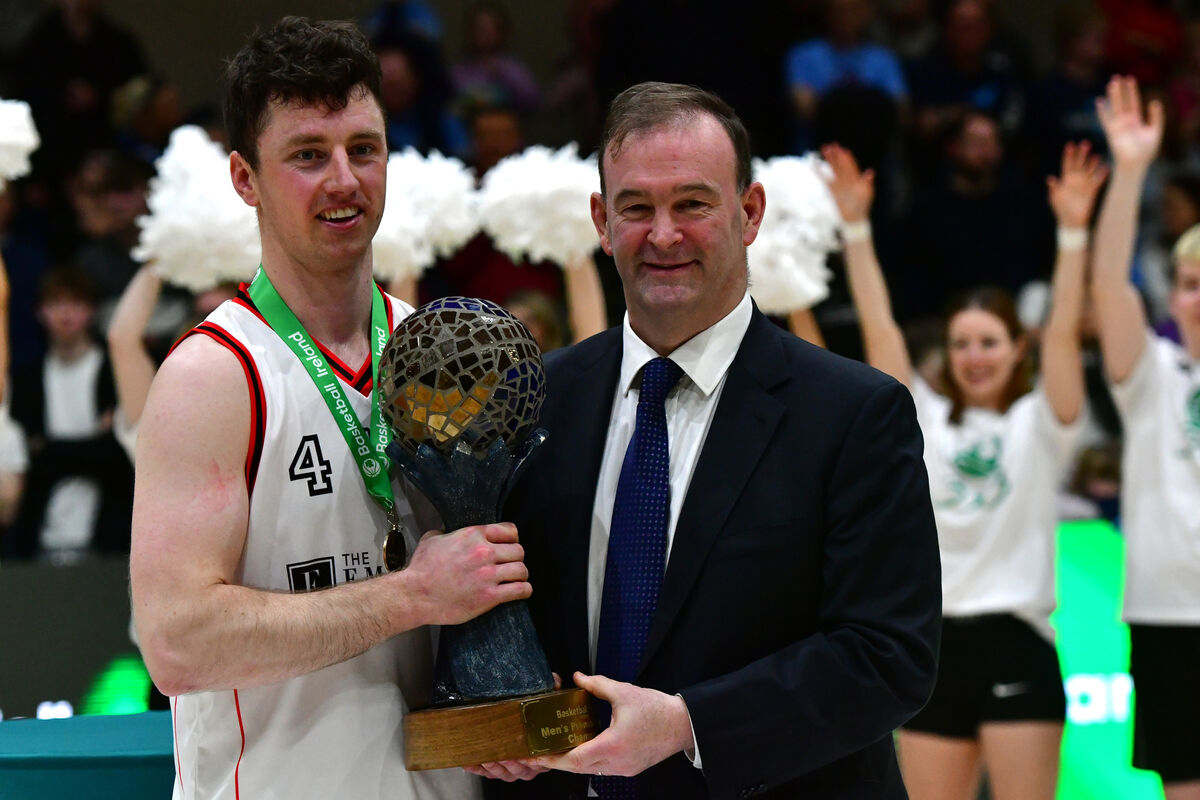  Ballincollig captain Adrian O'Sullivan receives the trophy from the CEO of Basketball John Feehan after their teams defeat of NUIG Maree in the Mens Super League Final at the National Basketball Arena, Tallaght today. Photograph Moya Nolan
