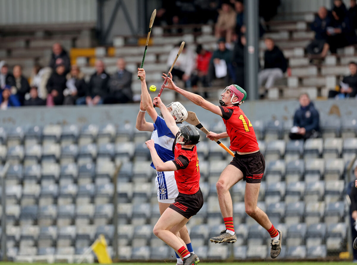 Gaelcholáiste Mhuire AG's Josh Ó Brosnacháin contests an aerial ball CBC pair Ben Mayer and Jack Trench. Picture: Jim Coughlan