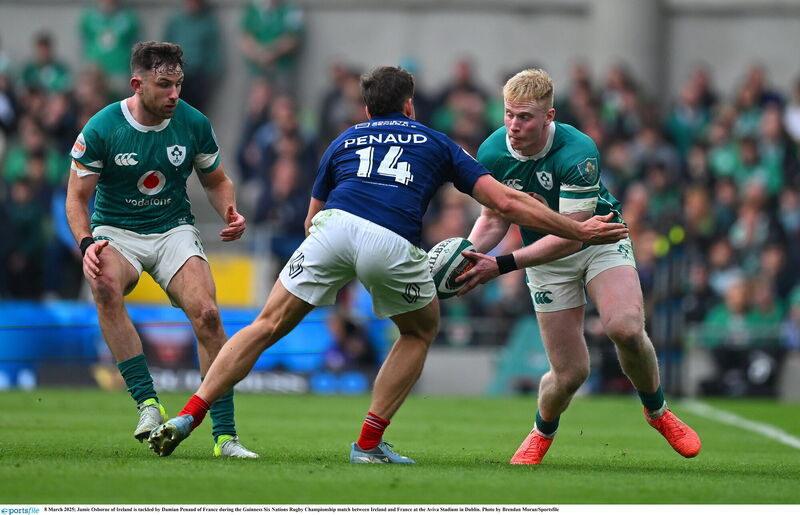 Jamie Osborne of Ireland is tackled by Damian Penaud of France. Picture: Brendan Moran/Sportsfile