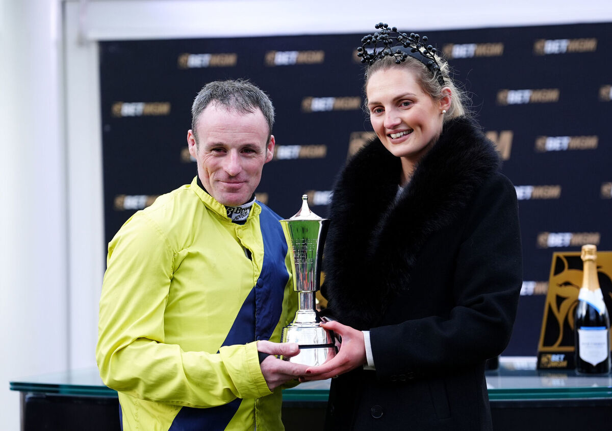 Sean Flanagan and Lauren Flanagan celebrate with the trophy. Picture: David Davies for The Jockey Club/PA Wire.