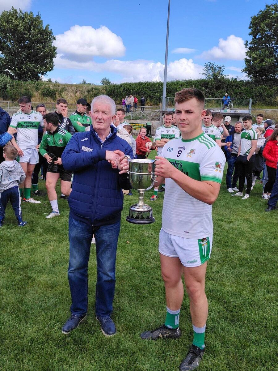 Kanturk captain Brian O'Sullivan receives the McCarthy Insurance Group Football League Division 3 trophy from John O'Mahony of Cork County Board after last year's win over Castletownbere. Picture: Donal Desmond