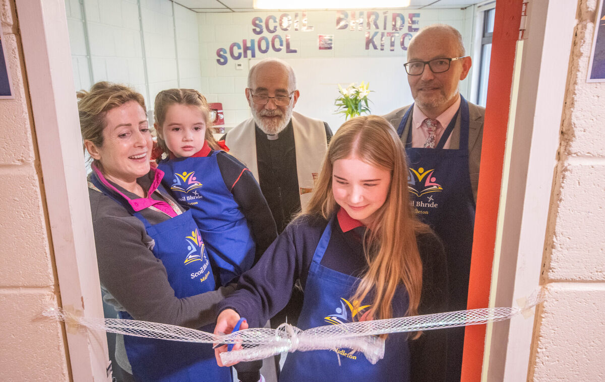 Sixth Class pupil Lena Jablonska cuts the tape to officially open the new Scoil Bhride School Kitchen in Midleton watched by Principal Seamus O'Connor, Fr John Ryan, Evelyn Madigan and Olivia Barrett. Picture: Howard Crowdy
