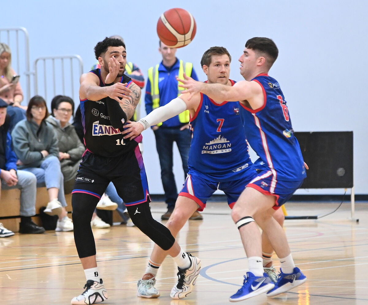 Eanna's Sean Jenkins gets off his pass from UCC Demons' Blake Murphy and Tobias Christensen during the Men's Super League at The Mardyke Arena . Picture: Eddie O'Hare