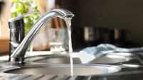 Water running from tap into kitchen sink