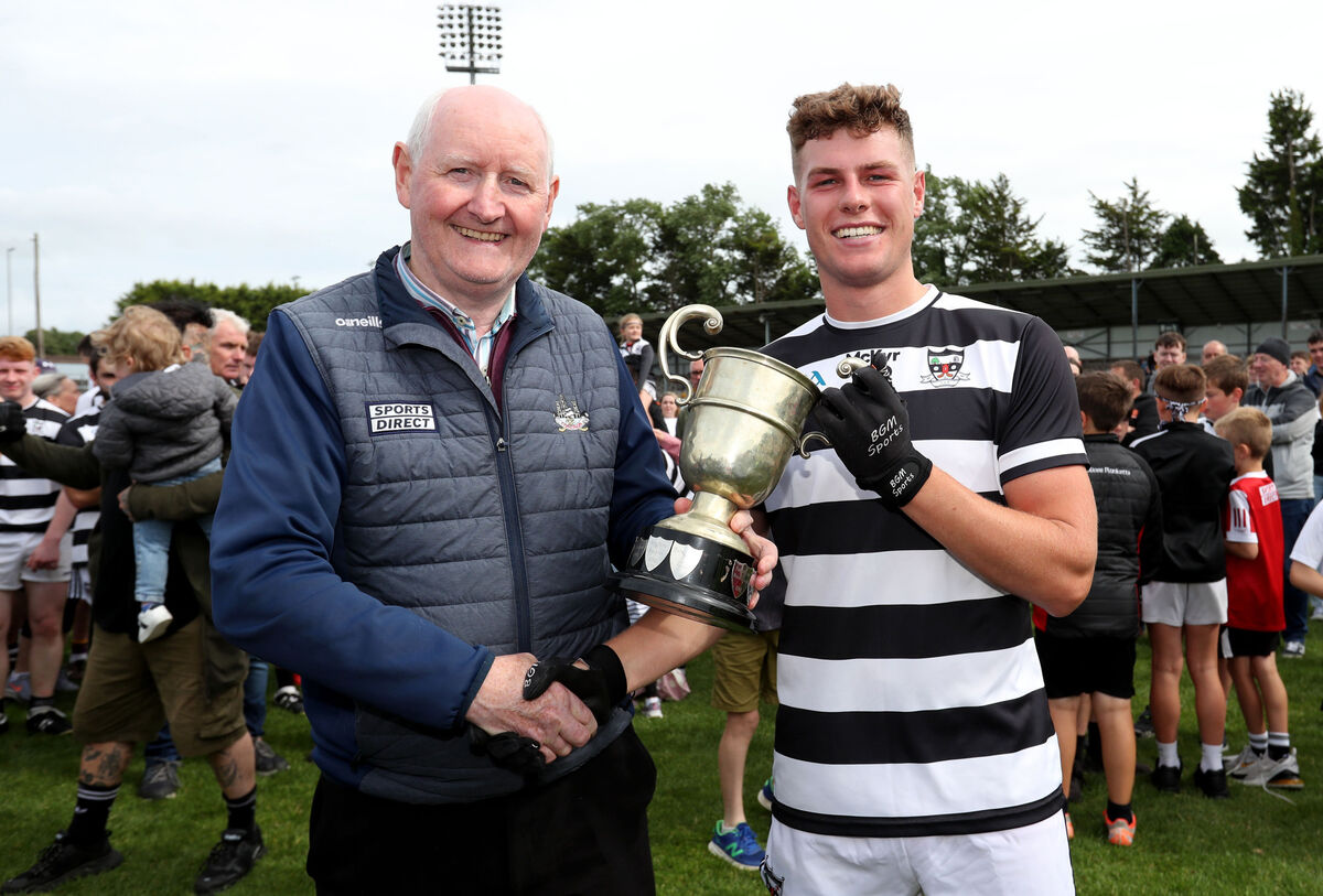  Pat Horgan, Cork County Board, presents the cup to Ronan McCarthy of St Oliver Plunkett's after the 2023 Cork County Confined Junior B Football Championship Final. Picture: Jim Coughlan