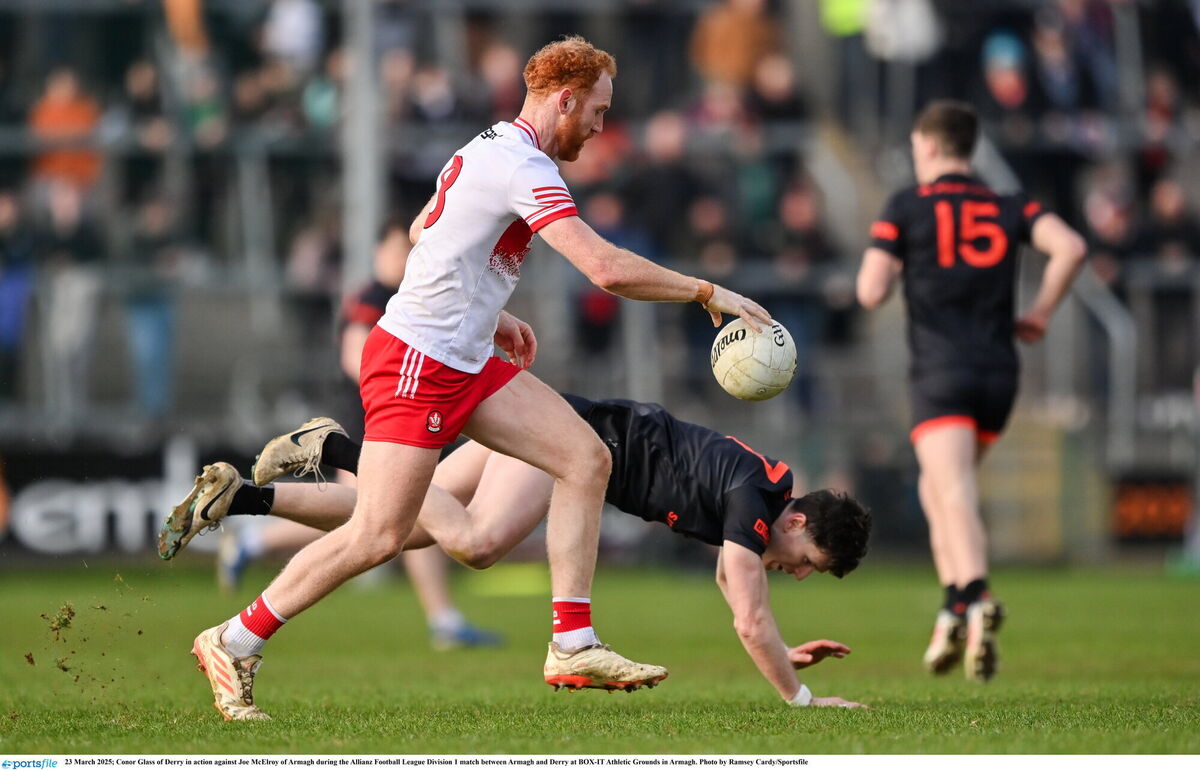Conor Glass of Derry goes past Joe McElroy of Armagh. Picture: Ramsey Cardy/Sportsfile