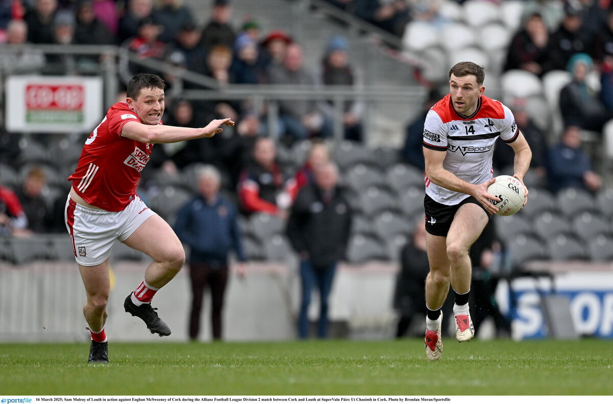 Sam Mulroy of Louth in action against Eoghan McSweeney of Cork. Picture: Brendan Moran/Sportsfile
