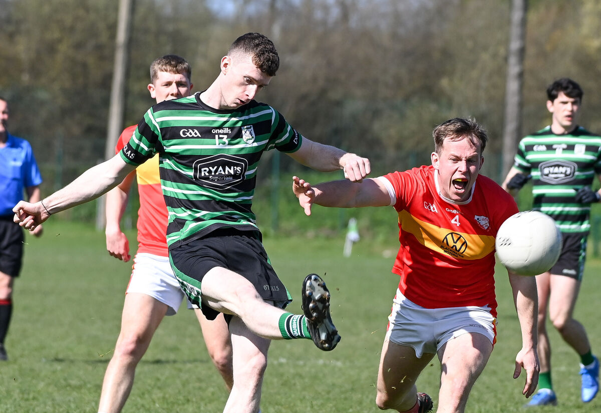  Douglas' Adam Cantwell shoots under pressure from Eire Og's Diarmid Dineen, during their Senior Football League clash at Douglas. Picture: David Keane.