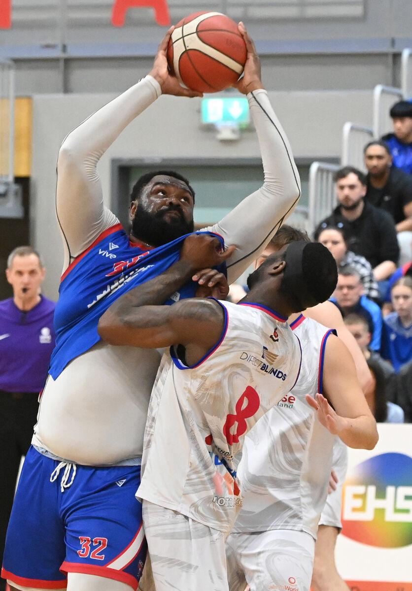 UCC Demons' Elijah Tillman is held by Energywise Ireland Neptune's Tamyrik Fields during the Men's Super League quarter final replay at the Mardyke Arena. Picture: Eddie O'Hare