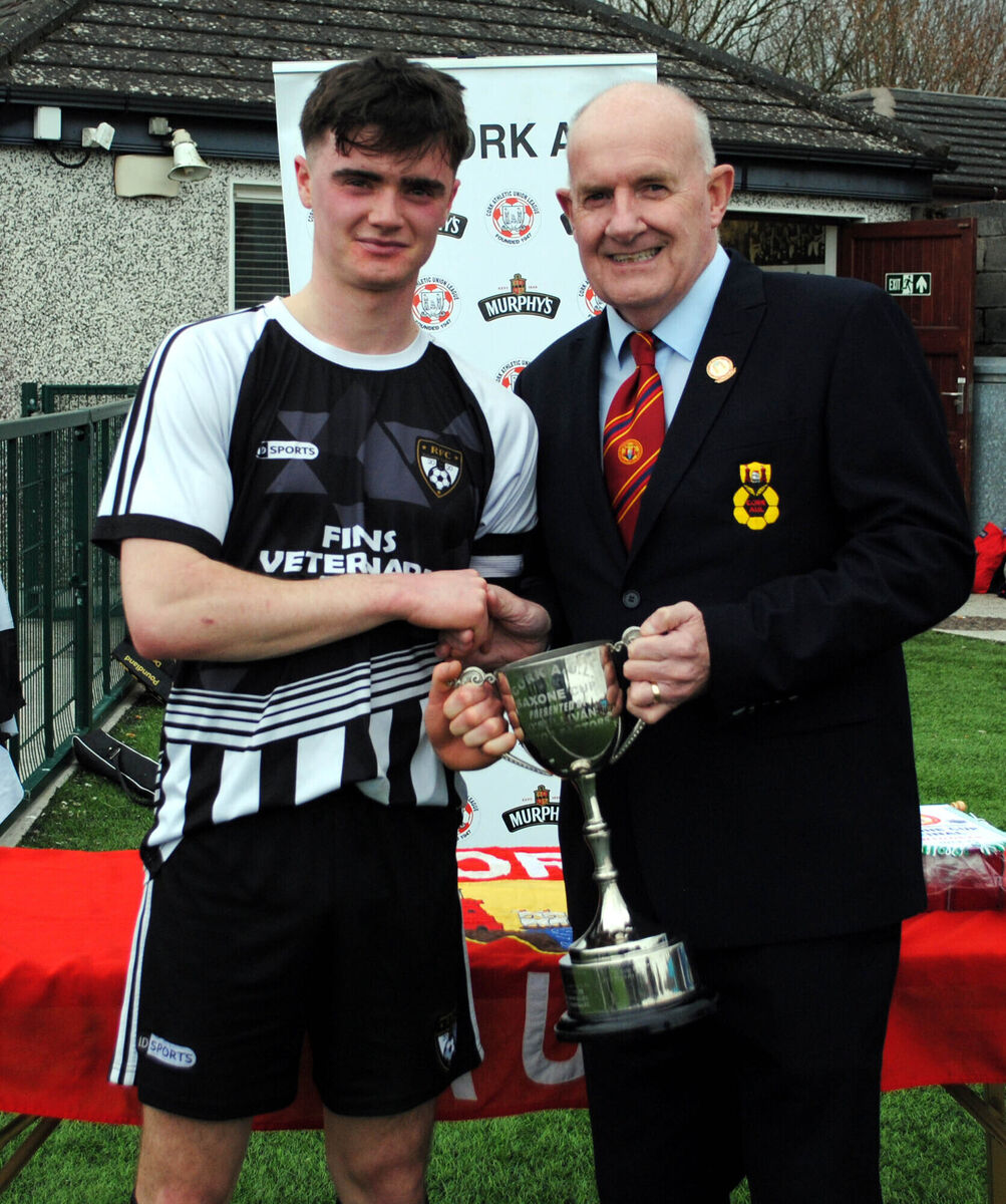 Rathcormac's Richard Morrisson is presented with the Saxone Cup by Dan O'Flynn (Cork AUL).