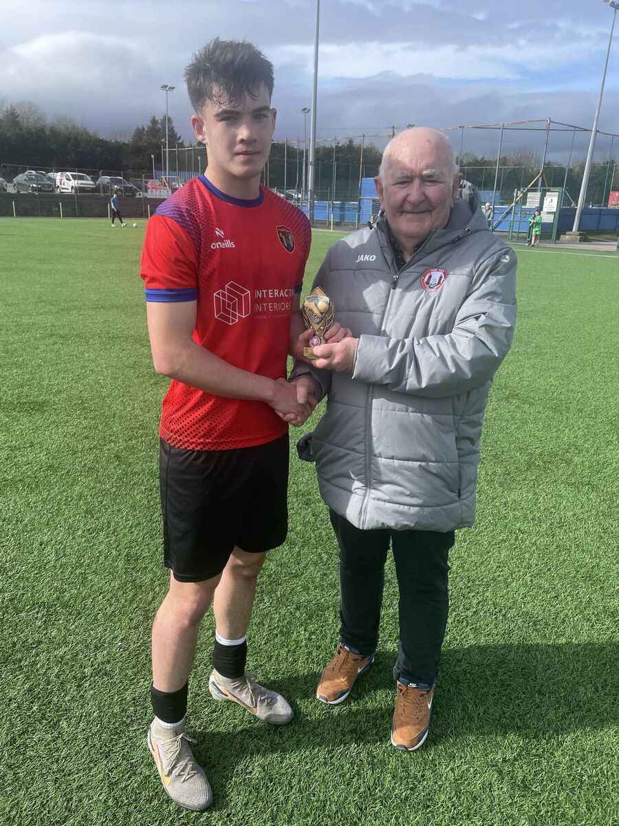 Peadar O’Leary from the Cork Youth League presents the Gary McCarthy Trophies Man of the Match award to Leeside U17 Premier League player James Grayem.