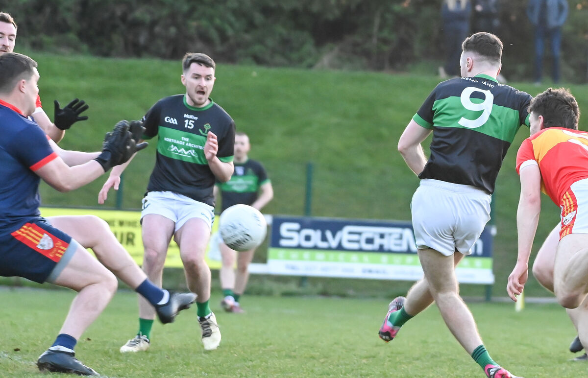 Nemo Rangers' Barry Cripps crashes the ball to the Éire Óg net past Chris Kelly. Picture: David Keane Nemo Rangers' Barry Cripps crashes the ball to the Éire Óg net past Chris Kelly. Picture: David Keane