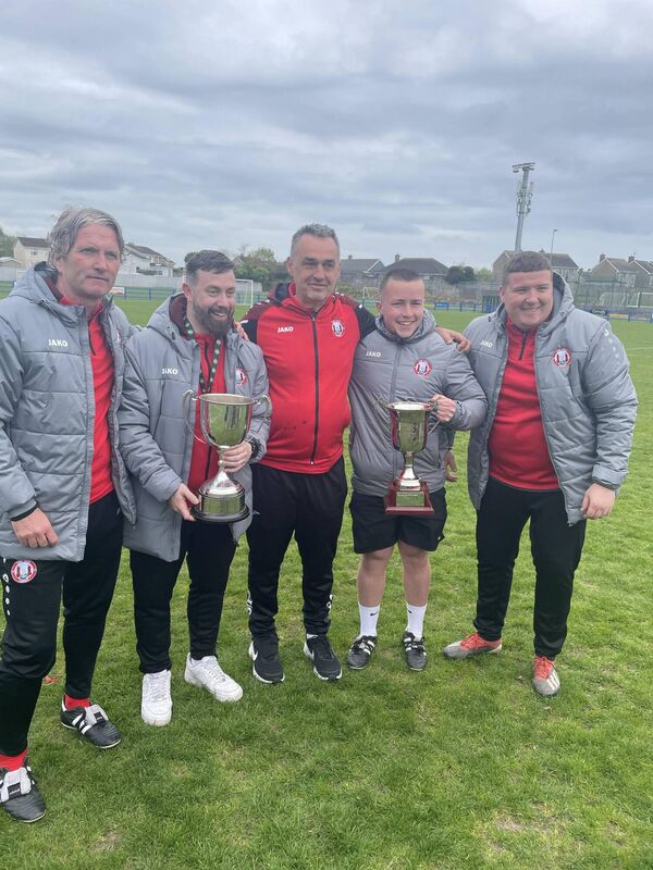 The Cork Youth League management team Lenny Forde, Louis Nolan (manager), Finbarr Lynch, Luke Noonan and James McDonald with the FAI and Munster Inter-League cups after their game against Mayo at Fairview Rangers pitch last Saturday evening.