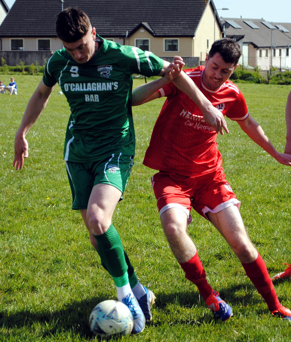 Coachford's Luke Casey manages to come away with posession, despite the best efforts from Village's Aaron Hennessy. Coachford's Luke Casey manages to come away with posession, despite the best efforts from Village's Aaron Hennessy.