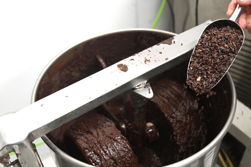  Melanging is the process of grinding the cacao nibs and cane sugar with granite stone wheels until the particle size reaches about 20 microns. Picture: Larry Cummins
