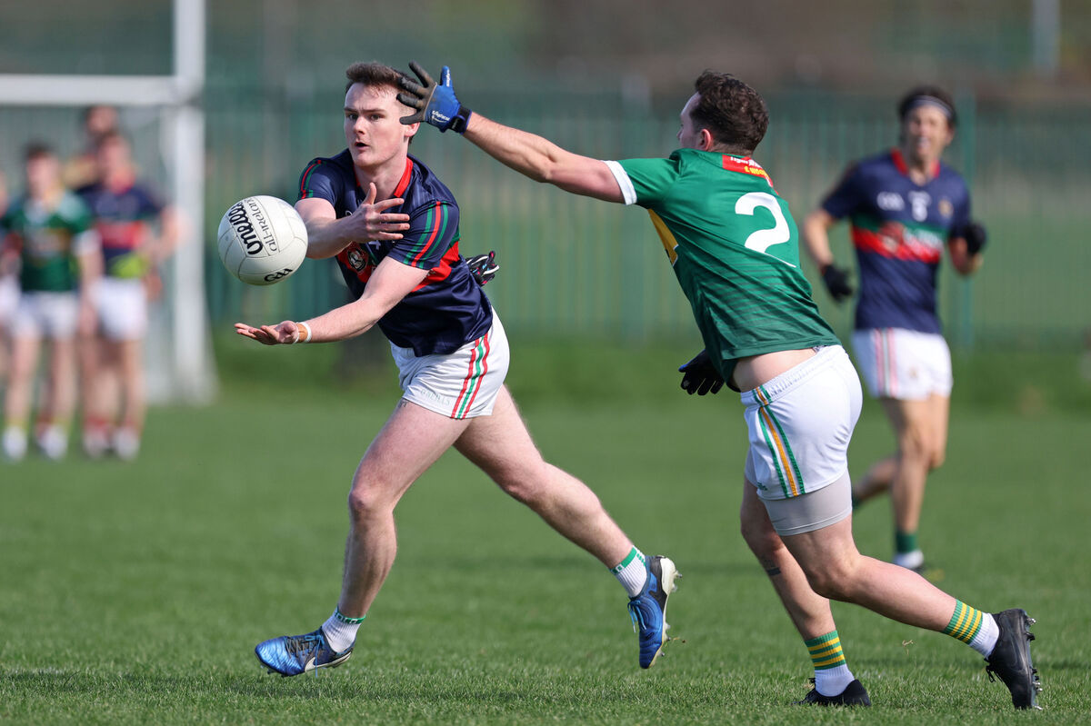 Clonakilty's Conor Daly gets his pass off under pressure from Luke Carroll, St Michael's. Picture: Jim Coughlan. Clonakilty's Conor Daly gets his pass off under pressure from Luke Carroll, St Michael's. Picture: Jim Coughlan.