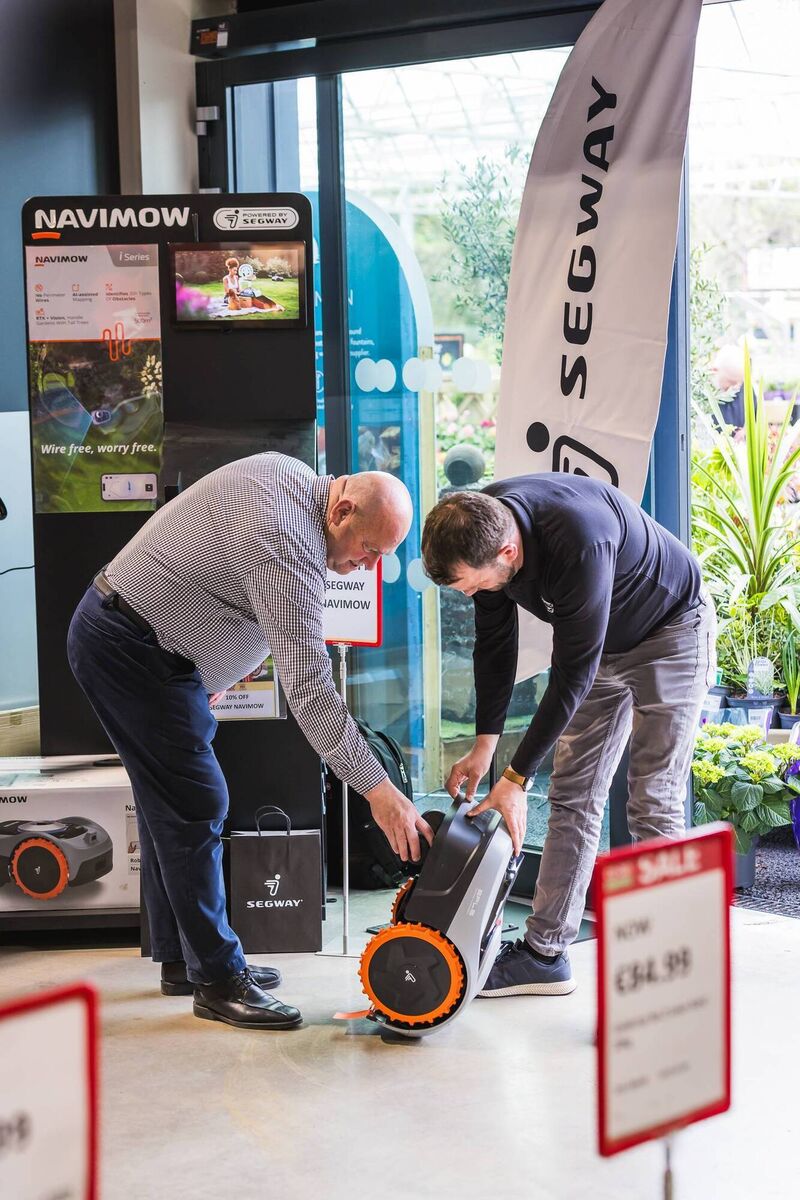 Customers checking out the Segway Navimow at the opening of the new store.