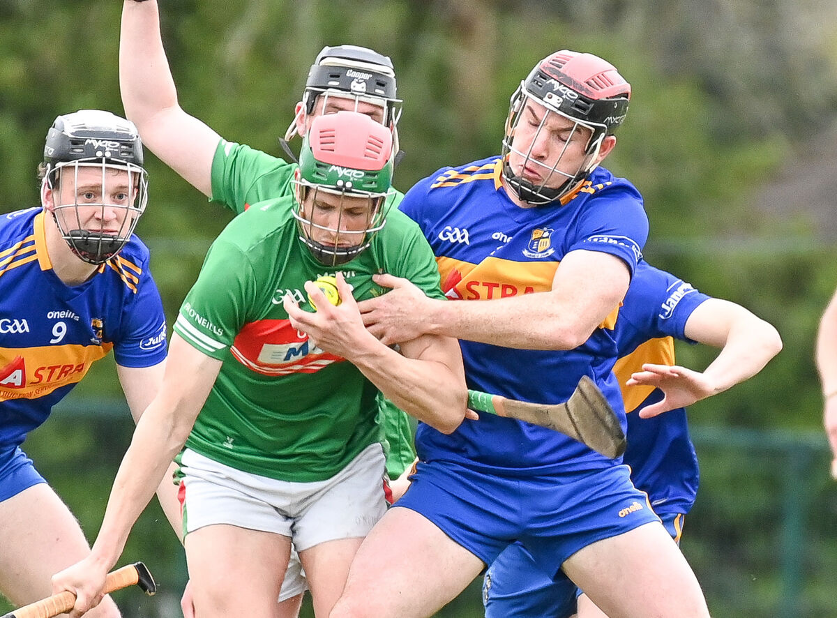  Fr O'Neill's Robert Cullinane is tackled by Carrigaline's Eanna Desmond, during their Senior Hurling League clash at Carrigaline.