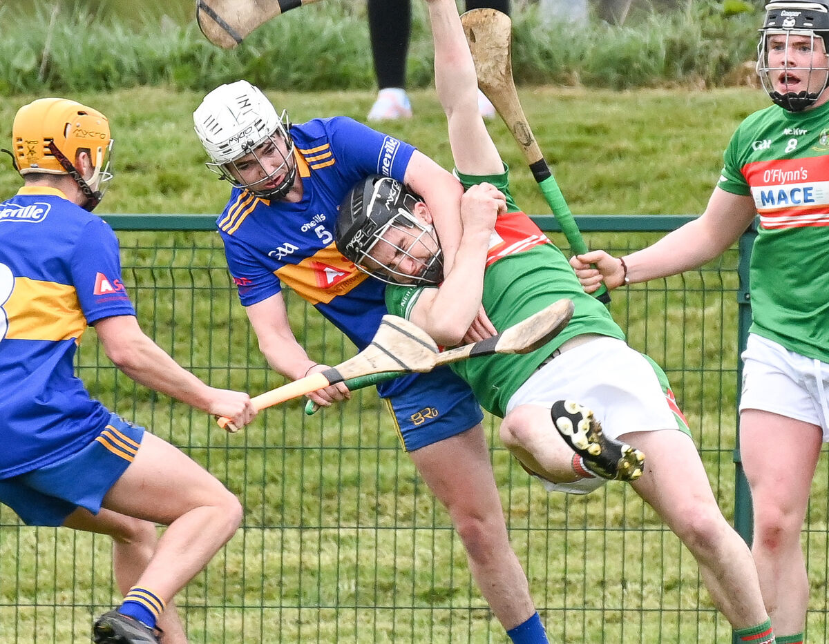  Fr O'Neill's John Millerick is tackled by Carrigaline's Harry Andrews, during their Senior Hurling League clash at Carrigaline.