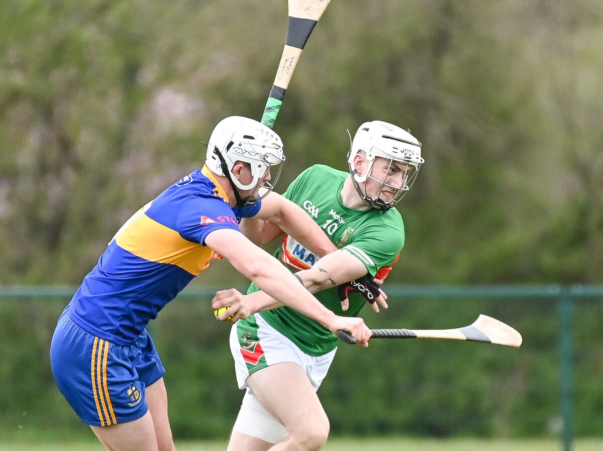  Fr O'Neill's Conor O'Leary battles past Carrigaline's Chris Vaughan, during their Senior Hurling League clash at Carrigaline.