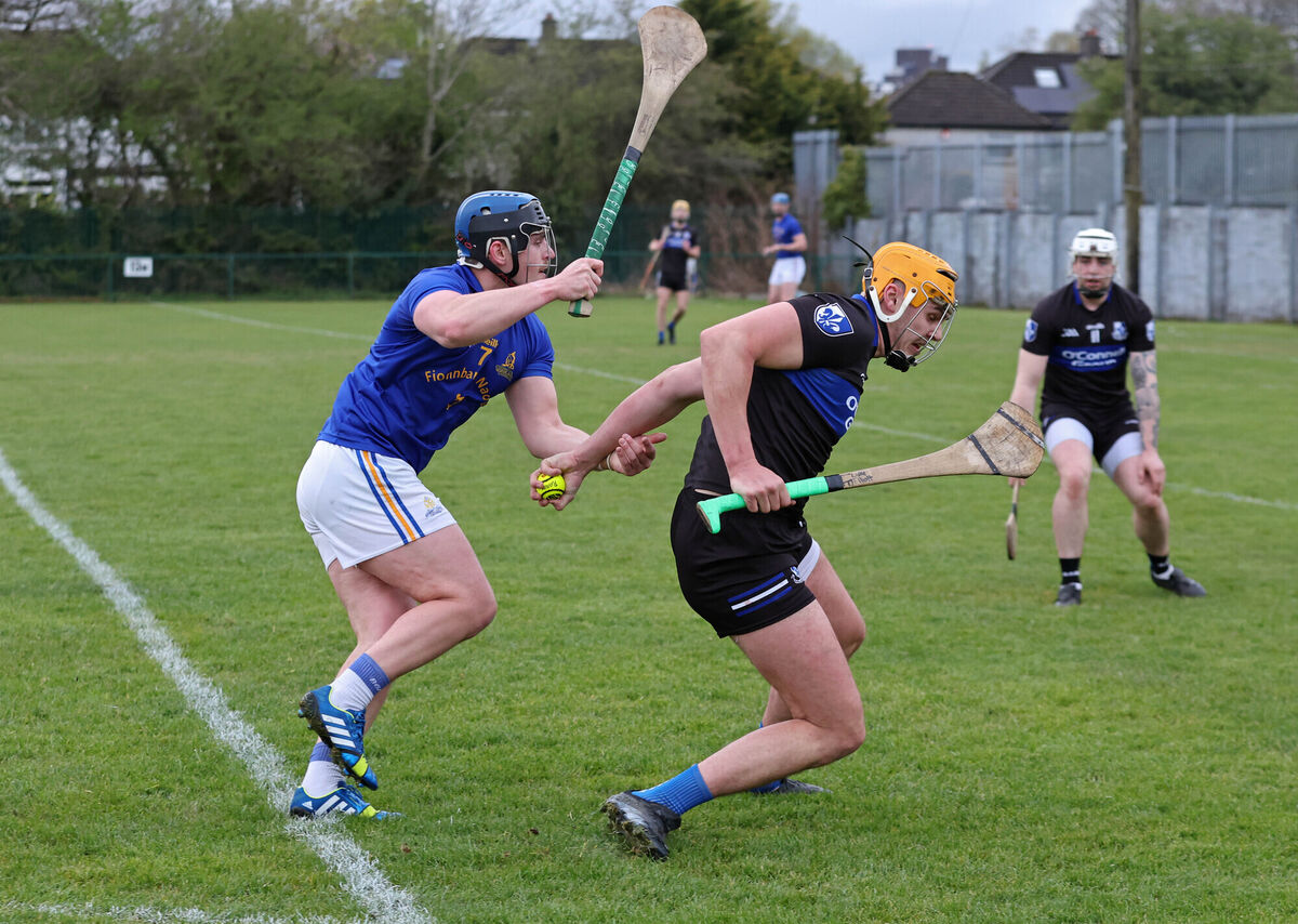 Sarsfields's Luke Elliott holds possession despite the attentions of St Finbarr's Ciarán Steele. Picture: Jim Coughlan