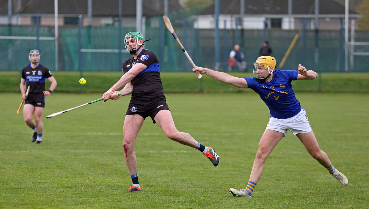 James Sweeney of Sarsfields gets his shot away as Cathal Crowley of St Finbarr's closes in. Picture: Jim Coughlan