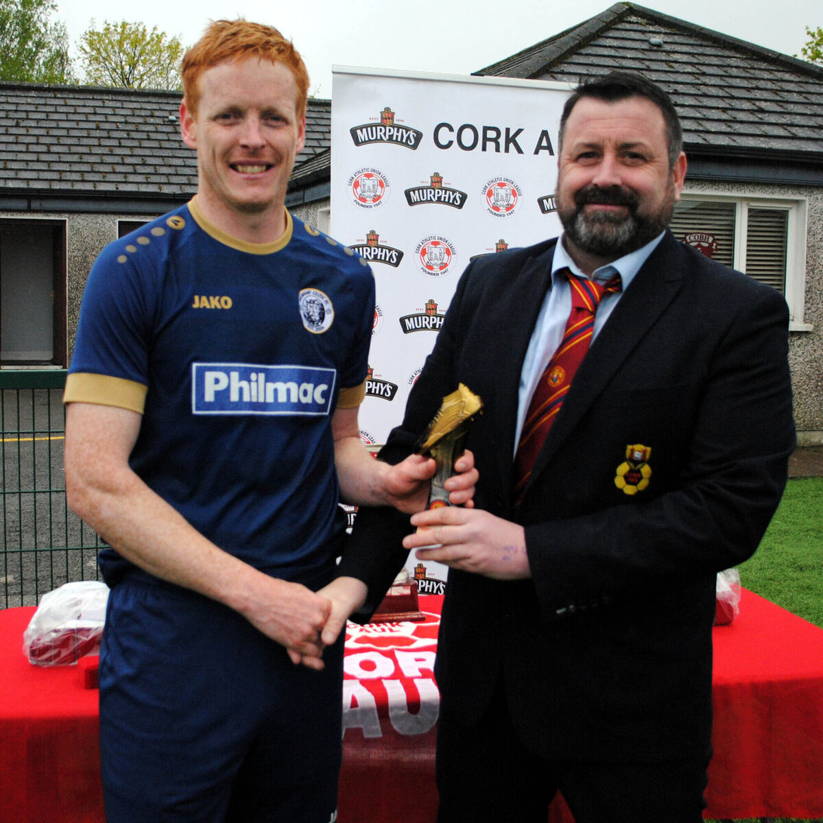 Belmount Celtic's James Kelleher is presented with the man of the match award (Sponsored by Gary McCarthy Tropies ) by Paul Pepper (Cork AUL).