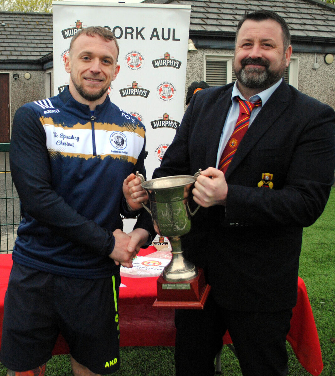 Paul Pepper (Cork AUL) presents the President's Cup to Belmount Celtic's captain Patrick O'Sullivan at St. Coleman's Park.