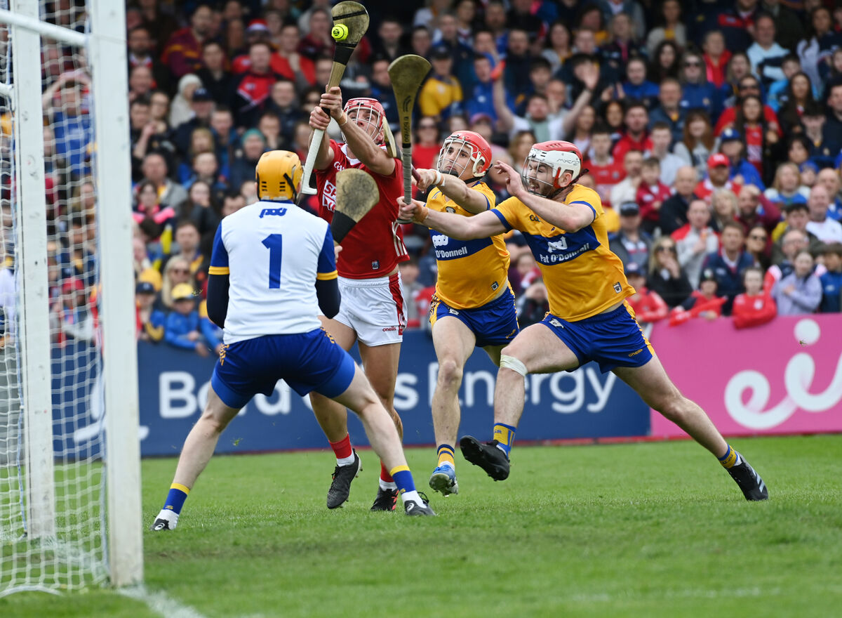 Cork's Brian Hayes scores the opening goal from Clare's Conor Leen, Daragh Lohan and goalkeeper Eibhear Quilligan. Picture: Eddie O'Hare