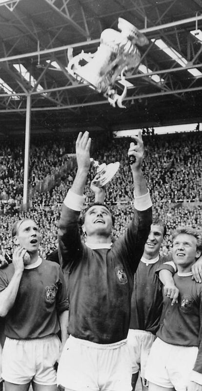 UP FOR THE CUP: Manchester United captain Noel Cantwell tosses the FA Cup aloft in 1963.