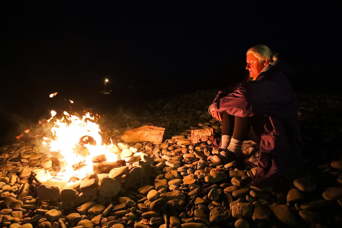 Nicola Fitzpatrick from Carrigaline doing some meditation next to a campfire during the Darkness into Light swim on Fountainstown Beach, Co. Cork. Picture: David Creedon Nicola Fitzpatrick from Carrigaline doing some meditation next to a campfire during the Darkness into Light swim on Fountainstown Beach, Co. Cork. Picture: David Creedon